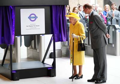 The queen and Prince Edward unveil a plaque at Paddington station. PA