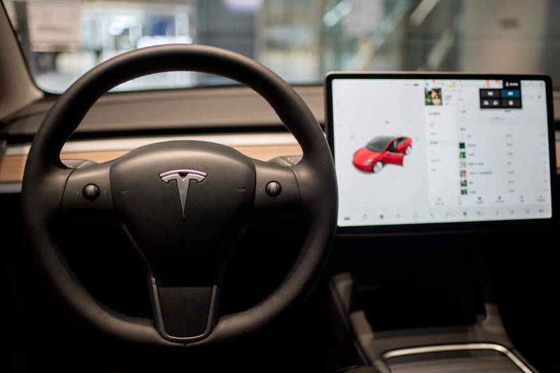 Drivers are capable of playing games on the giant screen on a Tesla car Model 3. AFP