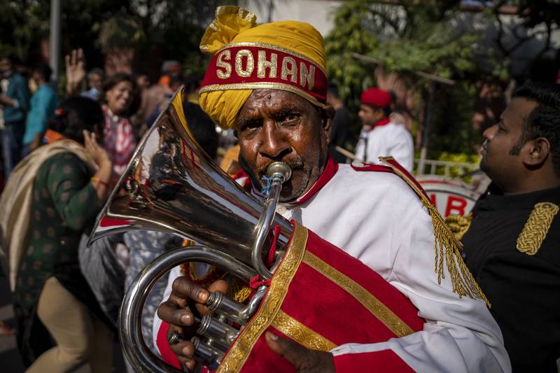 A brass band member plays as BJP supporters celebrate election results at the party headquarters in New Delhi. AP Photo