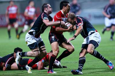 Seiichi Shimomura, centre, is part of a Japan squad that is the gold standard for sides such as the UAE, here in a Asian Five Nations rugby match at Dubai on May 10, 2013 and Singapore aspire to reach. Marwan Naamani / AFP