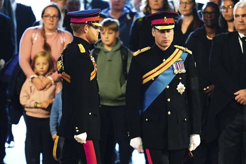 Prince William, right, and Prince Harry attend the vigil by Queen Elizabeth's grandchildren around the monarch's coffin in the Westminster Hall, in London. AP