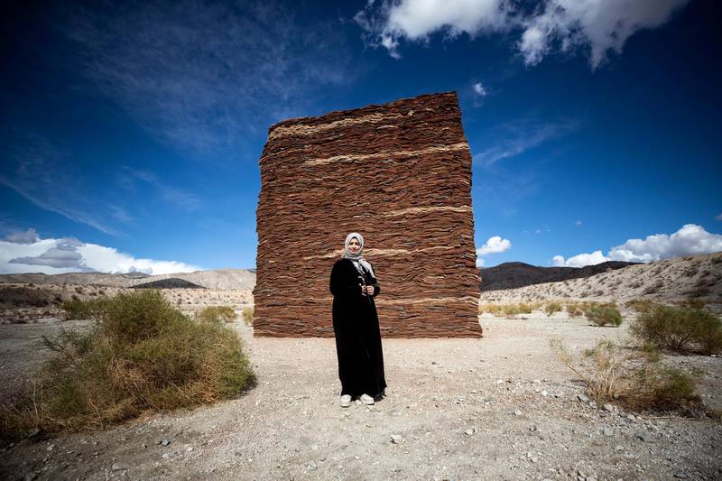 Saudi Arabian artist Zahrah Alghamdi poses in front of her art installation 'What Lies Behind the Walls', displayed as part of the Desert X exhibition near Palm Springs, California, USA. EPA