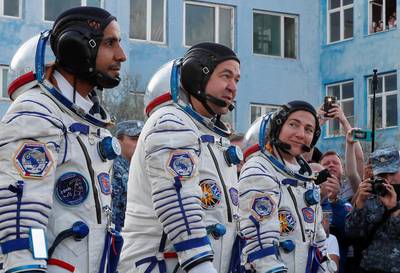 Jessica Meir, Oleg Skripochka and Hazza Ali Al Mansouri approach the launchpad at the Baikonur Cosmodrome. Shamil Zhumatov / Reuters