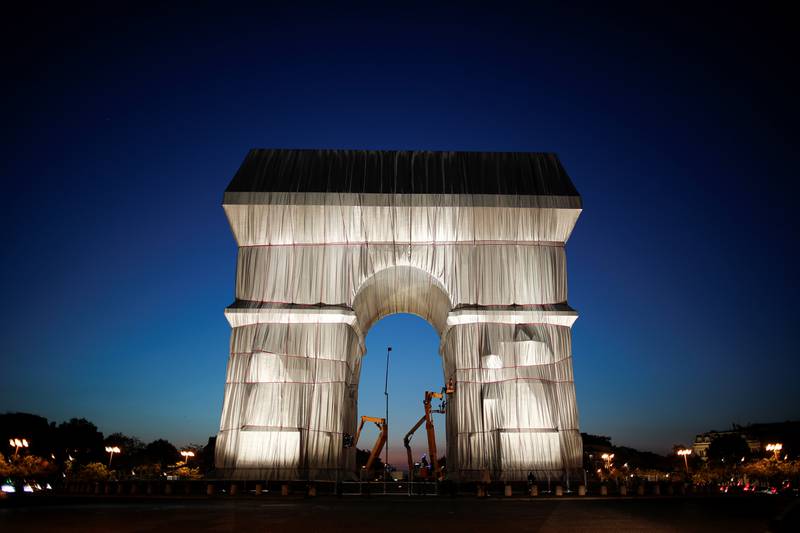 Workers install a shimmering wrapper to envelop the Arc de Triomphe monument, as part of a posthumous installation named 'L'Arc de Triomphe, Wrapped' and conceived by the late artists Christo and Jeanne-Claude, on the Champs-Elysees in Paris, on September 17, 2021. Reuters