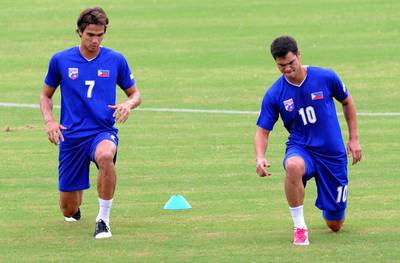 Philippine football team forward Phil Younghusband, right, trains with his brother James before the team's practice game on the eve of their match against Sri Lanka during the 2014 Fifa World Cup preliminary competition match at the Rizal football stadium in Manila.   AFP PHOTO / JAY DIRECTO