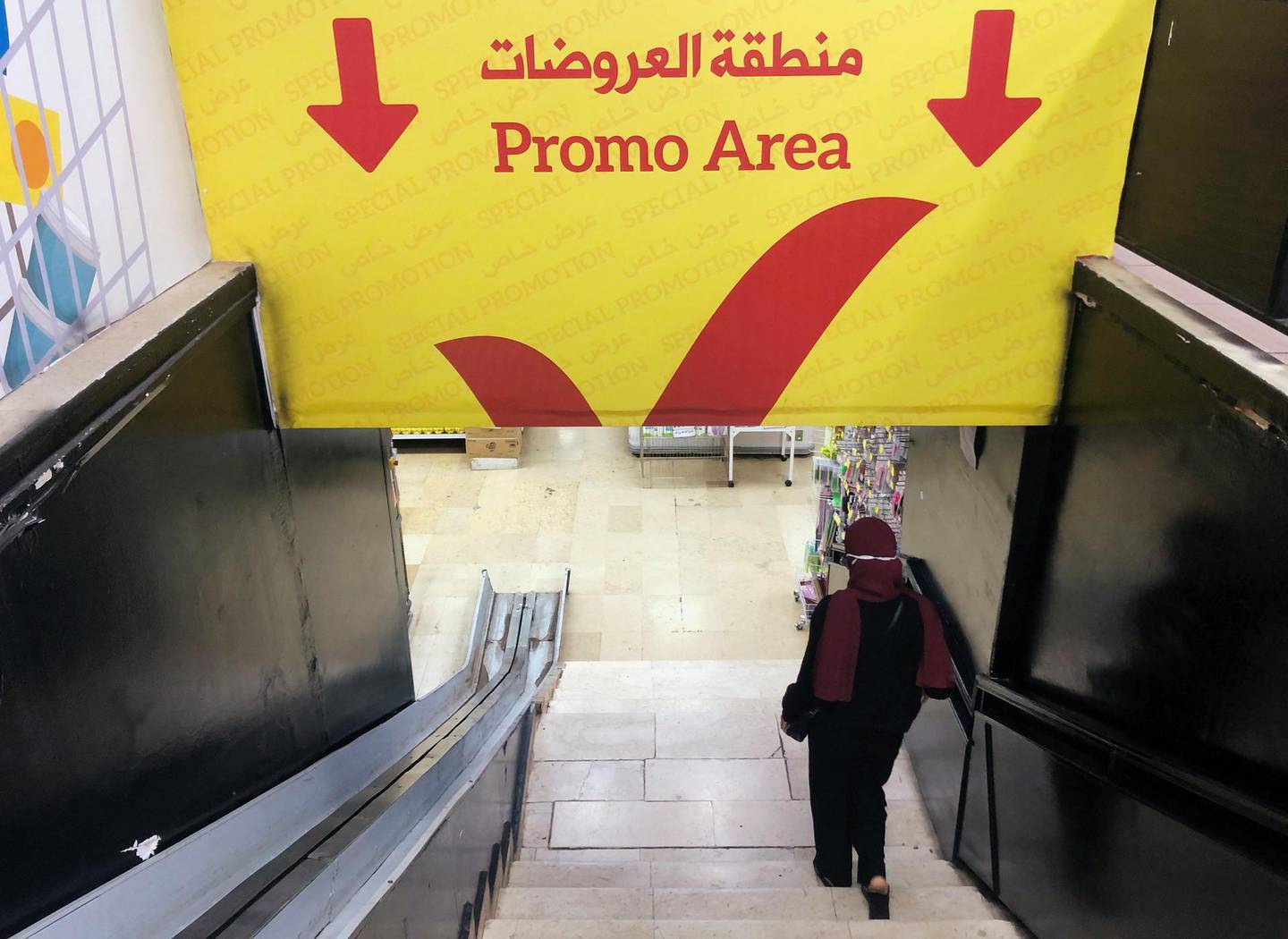 A woman walks down the stairs to a promotional area inside a supermarket in Beirut, Lebanon October 8, 2020. Picture taken October 8, 2020. REUTERS/Issam Abdallah