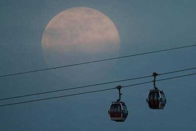 A full pink supermoon rises above the Emirates Air Line cable car in London, Britain. Reuters