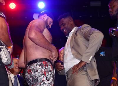 Francis Ngannou inspects Tyson Fury's flabby waist. Reuters.
