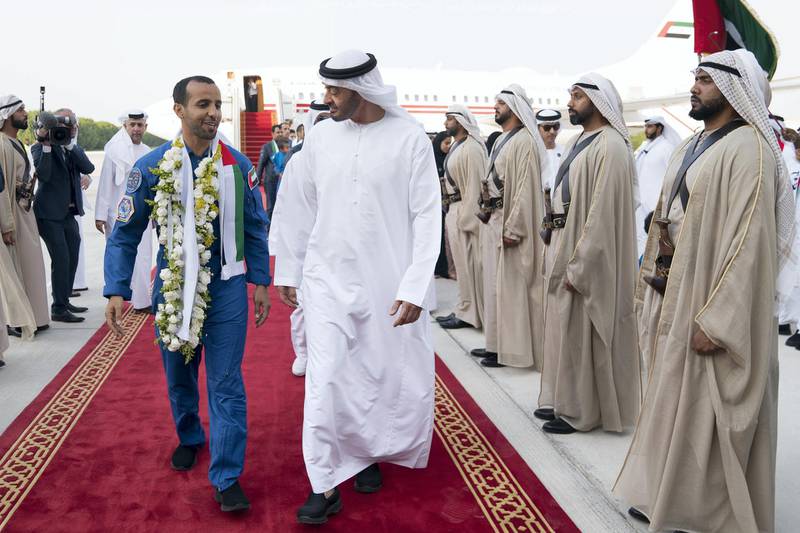 ABU DHABI, UNITED ARAB EMIRATES - October 12, 2019: HH Sheikh Mohamed bin Zayed Al Nahyan, Crown Prince of Abu Dhabi and Deputy Supreme Commander of the UAE Armed Forces (R), receives Hazza Ali Al Mansoori, the first UAE Astronaut to be deployed on a space mission to the International Space Station (ISS) (L) during a homecoming reception, at the Presidential Airport. 


( Mohamed Al Hammadi / Ministry of Presidential Affairs )
---