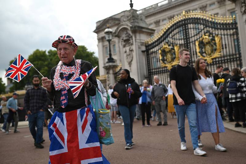 A royalist standing in front of Buckingham Palace. AFP