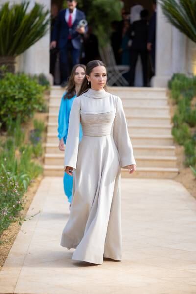 Jordan's Princess Iman wears a gown by Beirut label Ashi Studio, and her sister Princess Salma wears a blue Stella McCartney outfit