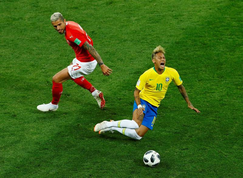 Neymar is tackled by Switzerland's Valon Behrami. Jason Cairnduff / Reuters
