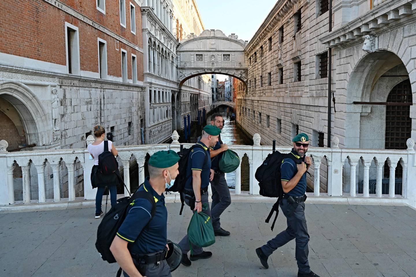 Italian police wak past the Ponte dei Sospiri during the G20 finance ministers in Venice. AFP