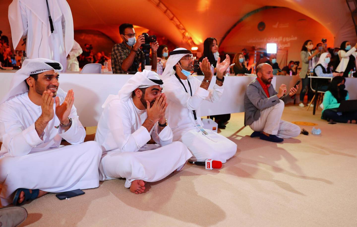 People react as they watch a big screen displaying the launch of the Hope Probe from Tanegashima Island in Japan, at the Mohammed bin Rashid Space Centre in Dubai, United Arab Emirates July 20, 2020. REUTERS/Ahmed Jadallah