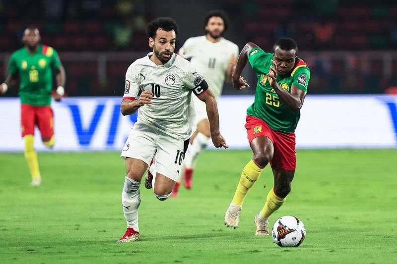 Egypt forward Mohamed Salah is chased by Cemeroon's Nouhou Tolo. AFP