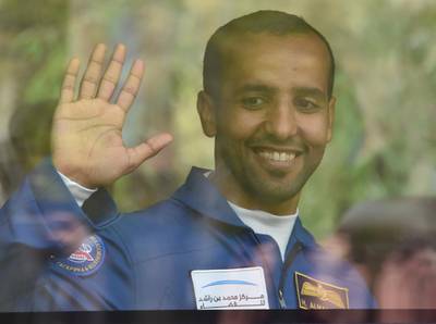 Hazza Al Mansouri waves to crowds as they leave for the launch pad. EPA