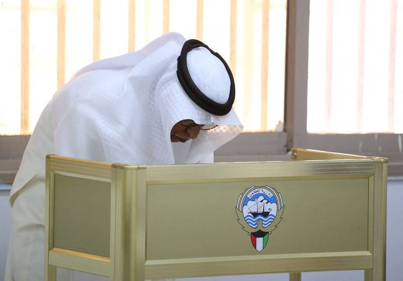 A Kuwaiti man casts his vote during parliamentary elections in Kuwait City. Kuwait is holding its most inclusive elections in a decade, with some opposition groups ending a boycott after the country's royal rulers pledged not to interfere with Parliament. AFP