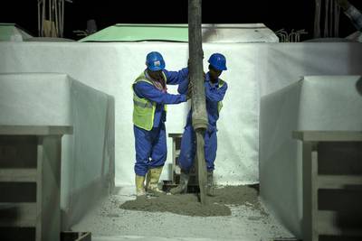 Concrete is poured at night when the temperature falls below 40C. Silvia Razgova / The National
