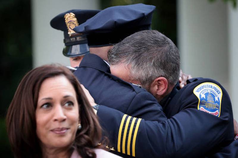 Kamala Harris looks on as DC Metropolitan Police Officer Michael Fanone hugs DC Metropolitan Police Chief Robert Contee after President Joe Biden delivered remarks honouring law enforcement in the Rose Garden of the White House on August 5, 2021. Getty Images