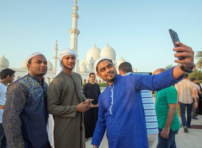 Abu Dhabi, UNITED ARAB EMIRATES - Faithfuls doing selfie after performing morning prayers on the first day of Eid-Al Fitr at the Sheikh Zayed Grand Mosque.  Leslie Pableo for The National