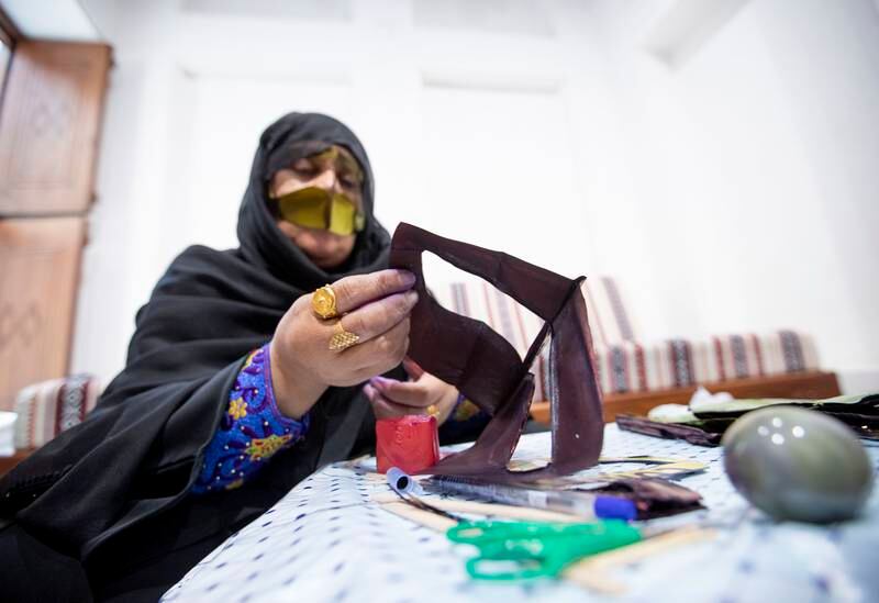 An Emirati woman making a burqa.