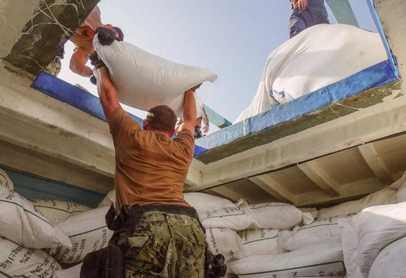 In this separate raid on another vessel on November 8, sailors from the destroyer USS The Sullivans sort the large quantity of urea fertiliser and ammonium perchlorate - used to make explosives.