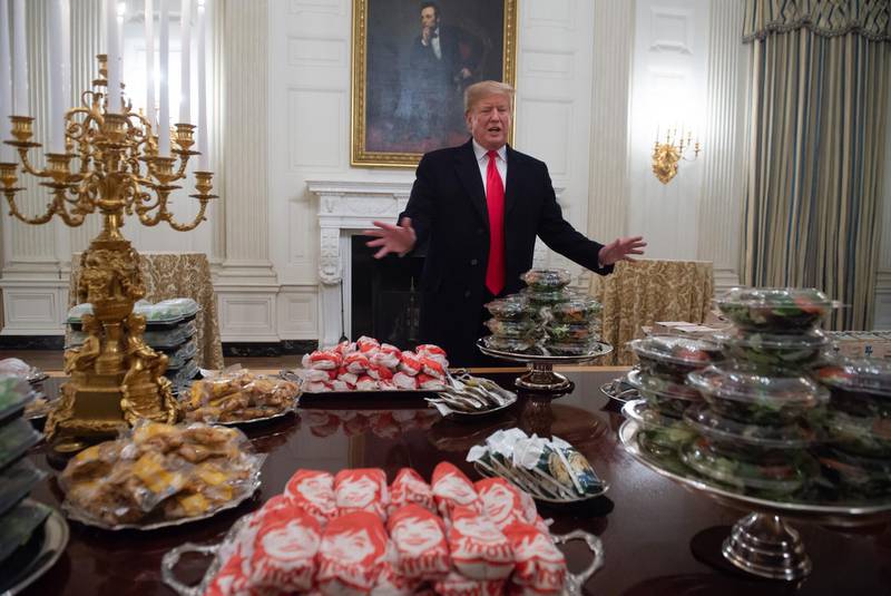 AFP presents a retrospective photo package of 60 pictures marking the 4-year presidency of President Trump.

US President Donald Trump speaks alongside fast food he purchased for a ceremony honoring the 2018 College Football Playoff National Champion Clemson Tigers in the State Dining Room of the White House in Washington, DC, January 14, 2019. - Trump says the White House chefs are furloughed due to the partial government shutdown. (Photo by SAUL LOEB / AFP)