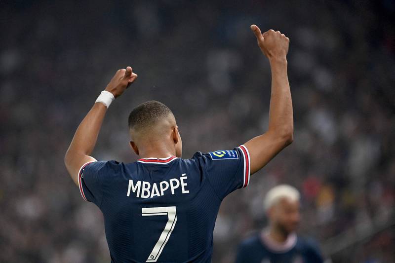 Paris Saint-Germain's French forward Kylian Mbappe celebrates after scoring a third goal during the French L1 football match between Paris Saint-Germain (PSG) and Metz at the Parc des Princes stadium in Paris on May 21, 2022.  (Photo by Anne-Christine POUJOULAT  /  AFP)