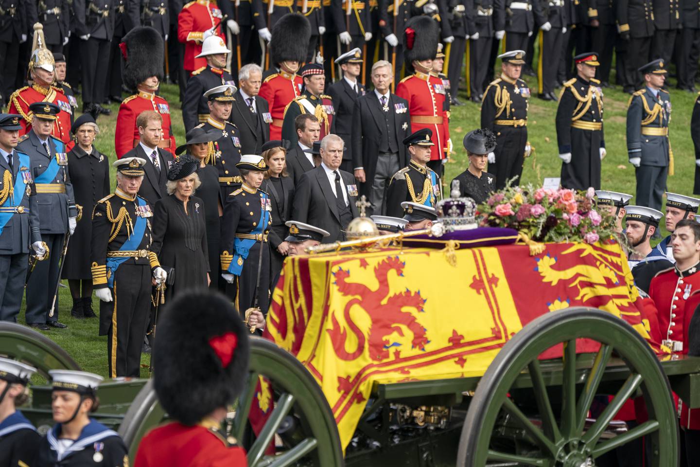 King Charles III, the Duke of Sussex, Queen Consort Camilla, the Duchess of Sussex, the Princess Royal, Princess Beatrice, Peter Phillips, the Duke of York, the Earl of Wessex and the Countess of Wessex look on as the State Gun Carriage carrying the coffin of Queen Elizabeth II arrives at Wellington Arch.