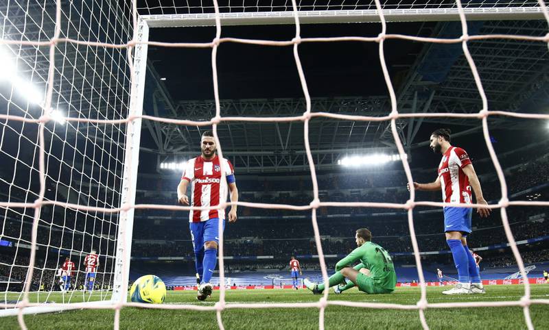 Atletico Madrid players look dejected after Asensio's goal. Reuters