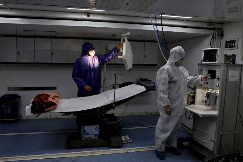 People in protective clothing work in a temporary 2,000-bed hospital for COVID-19 coronavirus patients set up by the Iranian army. AP Photo