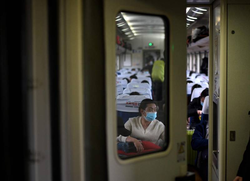 Passengers wearing face masks are seen as the train stops at a railway station in Macheng, in China’s central Hubei province on March 27, 2020. AFP