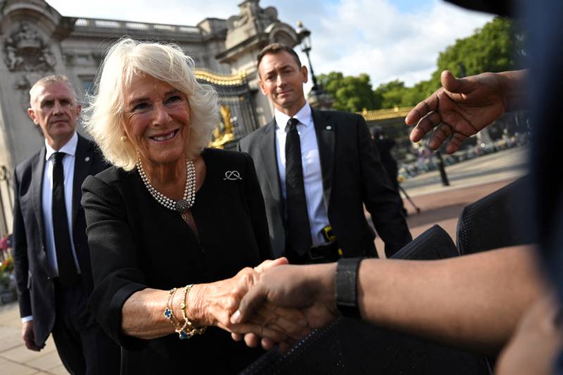 In pearl earrings, Camilla, Queen Consort, greets members of the crowd along the Mall, following the death of Queen Elizabeth II on September 10, 2022. AFP