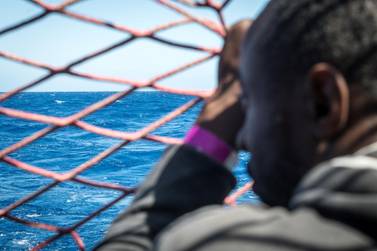 A migrant looks out at the Mediterranean from a rescue ship. Reuters