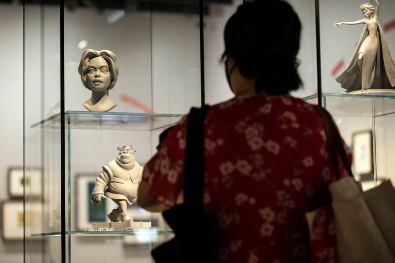 A visitor looks at figurines of Shrek used in preliminary researches for animated characters in animation movies. EPA