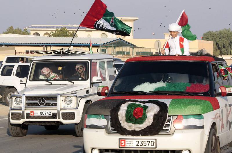 More than a hundred cars took to the streets of Umm al Quwain near the Clock roundabout as residents join in the festivities of the 42nd anniversary of the UAE. Jeffrey E Biteng / The National 
