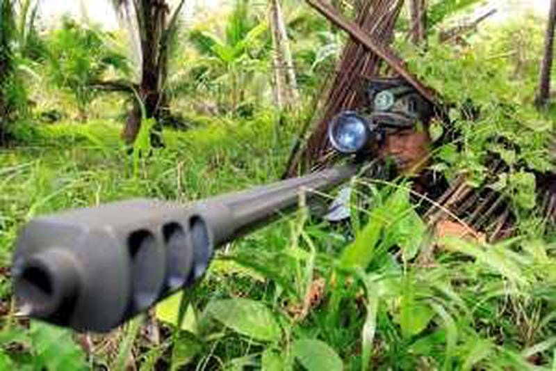 A Moro Islamic Liberation Front (MILF) rebel aims his .50 calibre Barret sniper rifle during a drill at camp Rajamuda in north Cotabato in Mindanao island September 22, 2009.   The leader of the Muslim insurgency in the southern Philippines warned that upcoming peace talks may be the last chance for a peaceful settlement with the government. Murad Ibrahim, chairman of the Moro Islamic Liberation Front (MILF), also warned of "anarchy" if the government fails to seal a peace accord.  AFP PHOTO/Mark Navales
