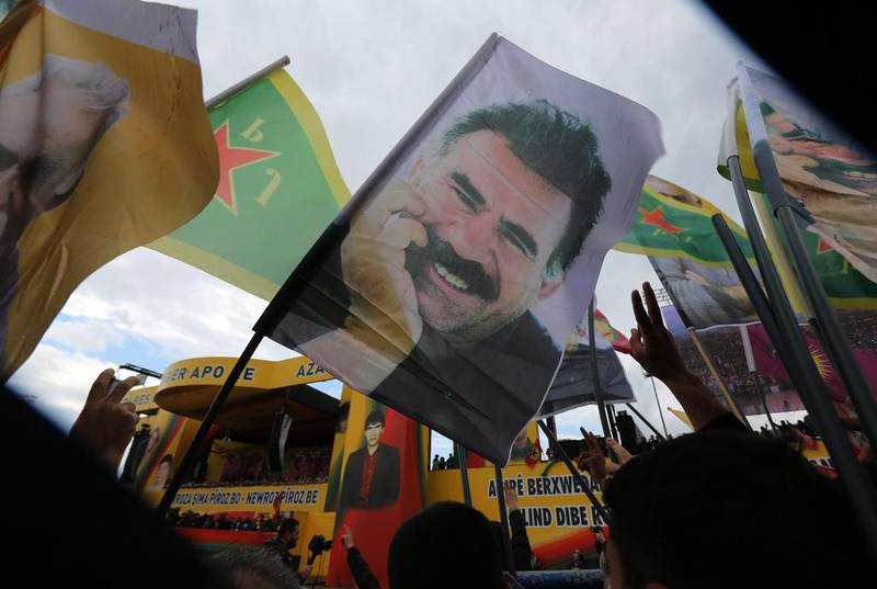 Cheering supporters hold posters of imprisoned Kurdish rebel leader Abdullah Ocalan during Nowruz celebrations in southeastern Turkey (AP Photo/Burhan Ozbilici)