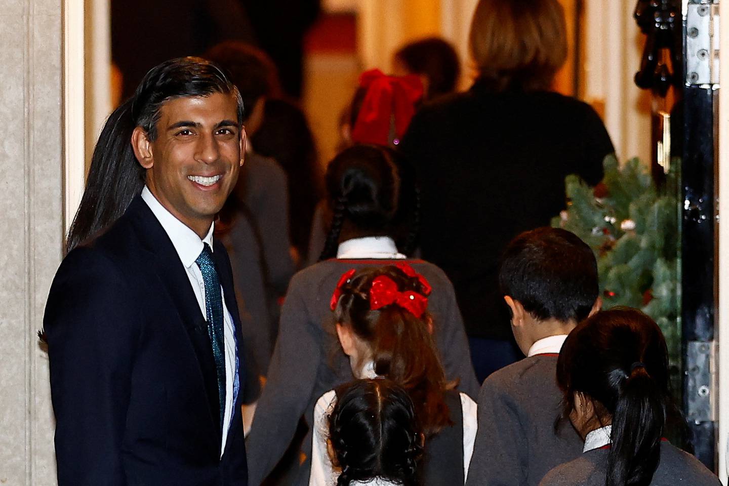 British Prime Minister Rishi Sunak looks on, during the switching on the Christmas tree lights ceremony. On Tuesday he will host a viewing of the England v Wales football match in Downing Street. Reuters