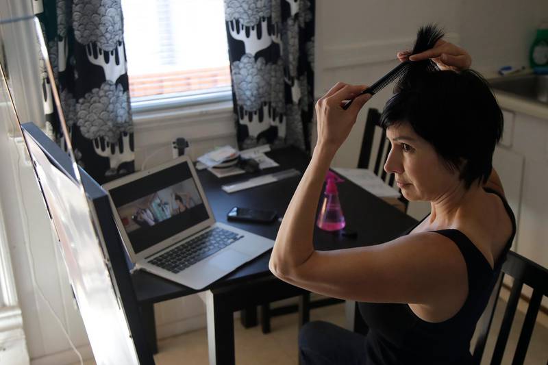 Danielle Espinoza, right, listens as hairstylist Wendy Newsome, in Portland, Oregon., provides a virtual guided haircut over their computers through Zoom during the coronavirus outbreak in San Francisco. AP Photo