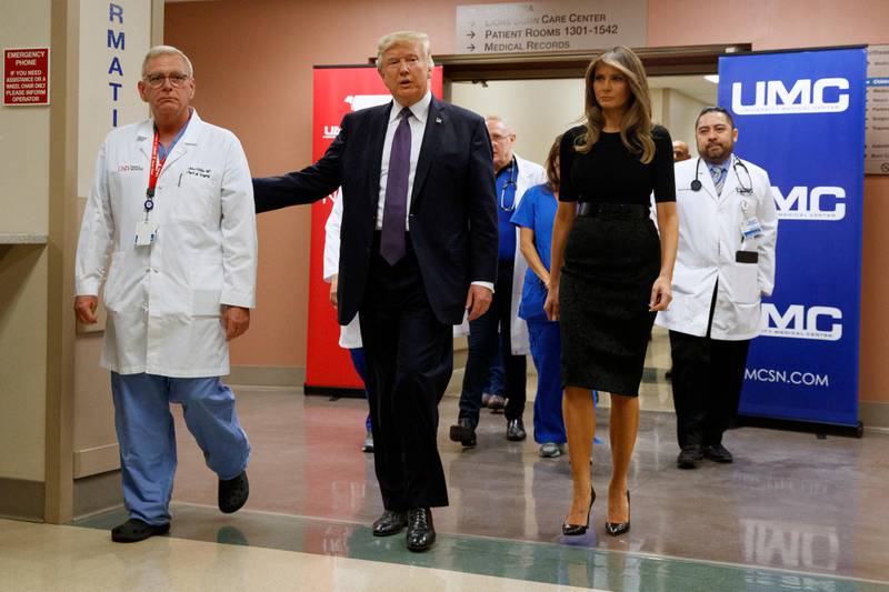 President Donald Trump and first lady Melania Trump walk through University Medical Center after meeting with victims of the mass shooting. Evan Vucci / AP Photo