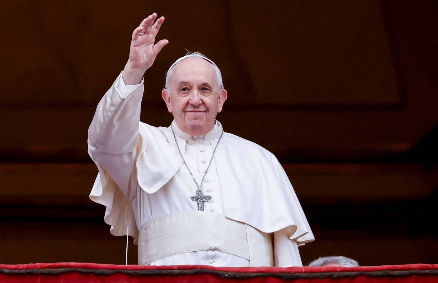 Pope Francis waves to worshippers after delivering his traditional Urbi et Orbi message from the balcony of St Peter's Basilica. Reuters 