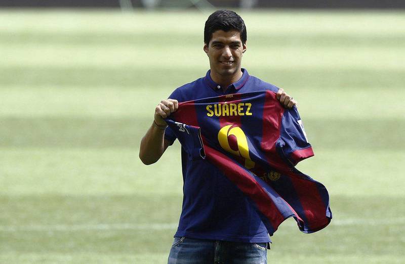 Luis Suarez signs for Barcelona from Liverpool on August 19, 2014. AFP