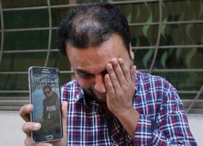 A relative weeps while showing the picture of Sohail Shahid, a Pakistani citizen who was killed in Christchurch mosque shootings. AP Photo