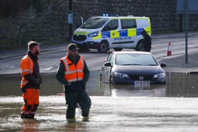 A stranded vehicle in flood water in Belper, Derbyshire. PA