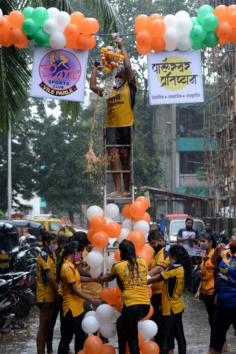 A group of girls take part in a Dahi Handi using a ladder in Mumbai. AFP