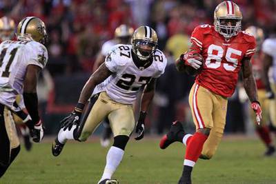 San Francisco 49ers tight end Vernon Davis (85) runs from New Orleans Saints free safety Malcolm Jenkins (27) and strong safety Roman Harper (41) during the fourth quarter of an NFL divisional playoff football game Saturday, Jan. 14, 2012, in San Francisco.  (AP Photo/Marcio Jose Sanchez)