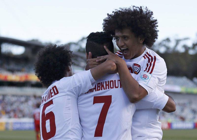 Ali Mabkhout, centre, is mobbed by teammates Mohamed Abdulrahman, left, and creator Omar Abdulrahman after the striker opened the scoring for the UAE just 14 seconds into their match against Bahrain. im Wimborne / Getty