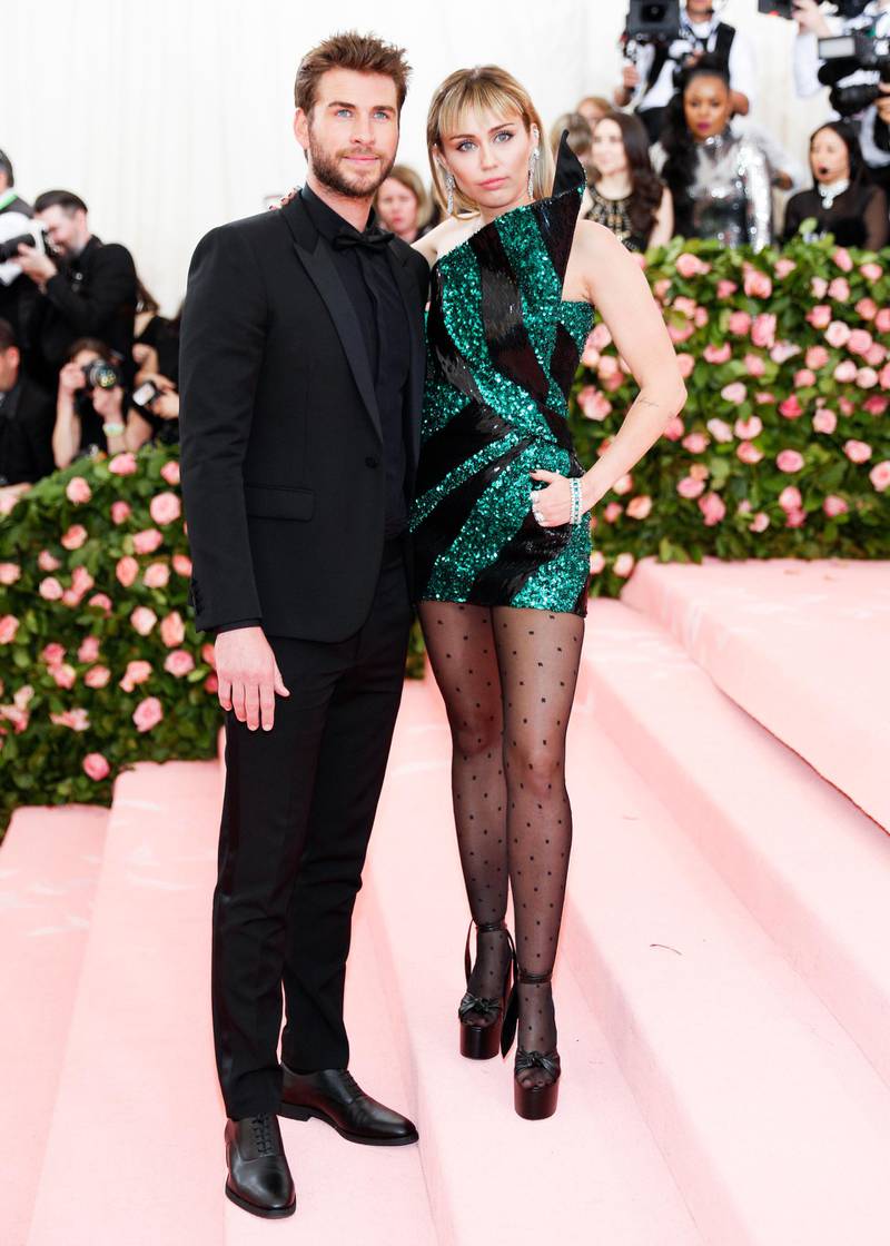 epa07552449 Miley Cyrus and Liam Hemsworth arrive on the red carpet for the 2019 Met Gala, the annual benefit for the Metropolitan Museum of Art's Costume Institute, in New York, New York, USA, 06 May 2019. The event coincides with the Met Costume Institute's new spring 2019 exhibition, 'Camp: Notes on Fashion', which runs from 09 May until 08 September 2019.  EPA-EFE/JUSTIN LANE