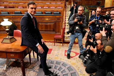 Pedro Sanchez poses for photographers after winning the vote. AFP